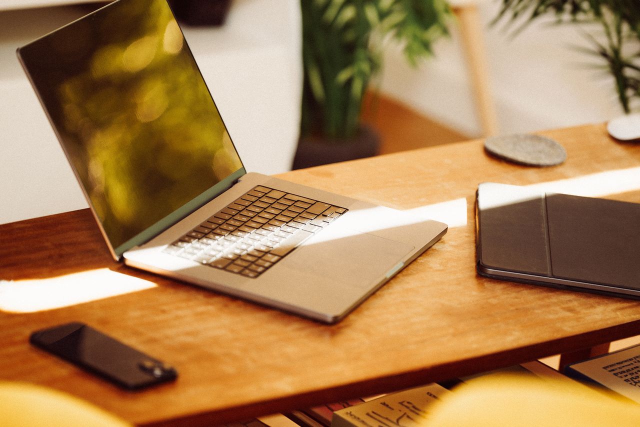 Crafting Captivating Headlines: Your awesome post title goes here A cozy home office setup with a laptop, smartphone, and tablet on a wooden desk indoors.